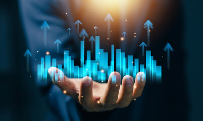 Business professional holding rising bar charts with upward arrows, representing data analytics, business growth, performance metrics, financial success, and strategic planning in digital economy.