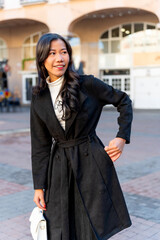 Latina businesswoman of asian descent walking in city