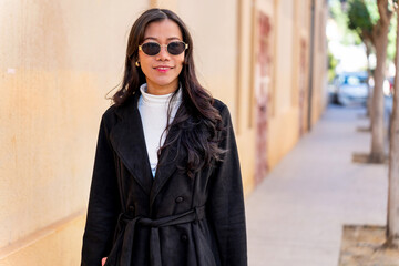 Latina businesswoman of asian descent smiling wearing sunglasses