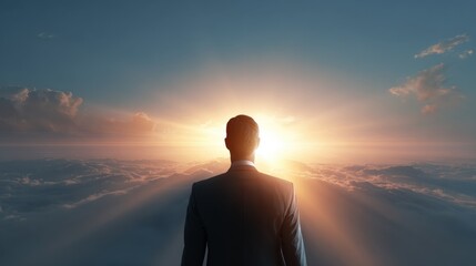Man in suit standing on clouds looking at sunrise with sun rays sky business