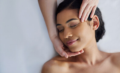 Naklejka premium Spa, facial and above of woman with hands for massage, beauty treatment and pamper at luxury resort. Salon, space and masseuse with person for wellness, stress relief and skincare service for health