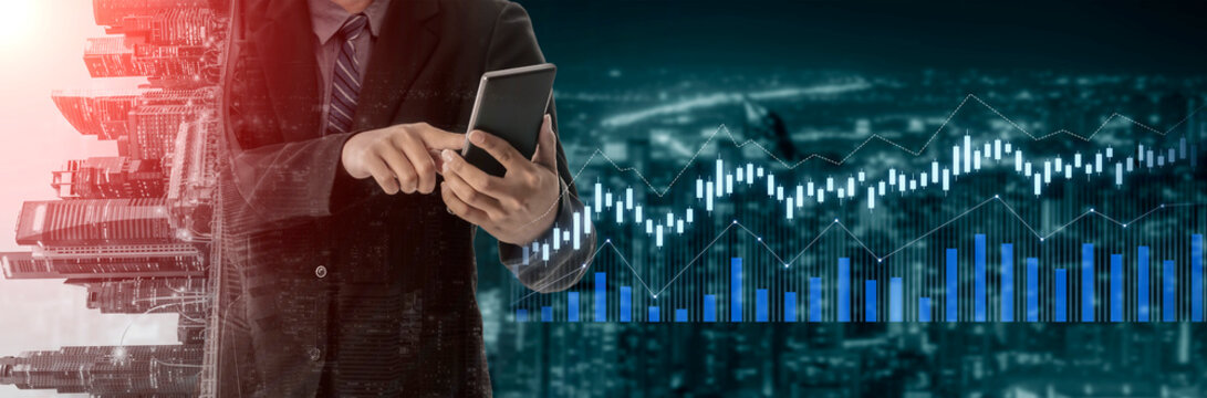 A businessman engages with a smartphone in a modern office setting, showcasing digital financial graphs to reflect the integration of technology in the finance industry. Scalp - Powered by Adobe