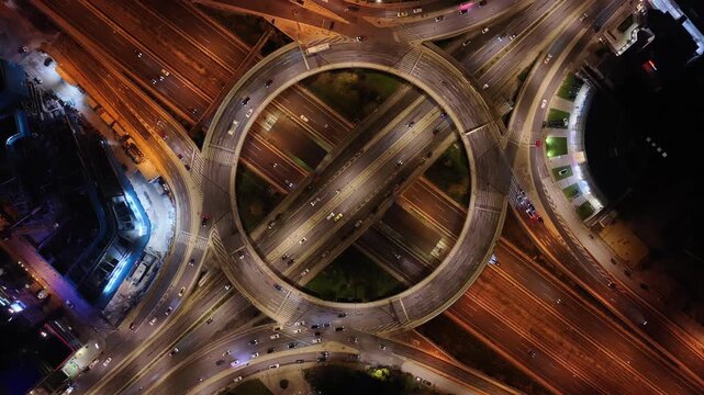 Aerial drone night timelapse top down video of illuminated urban elevated toll ring road junction and interchange overpass passing through Kifisias Avenue, Attica, Greece