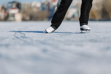 Skaters feet gliding across a frozen lake surface