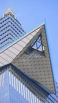 New York, NY - Dec. 21. 2025: The Edge observation deck with glass floor and tourists at Hudson Yards. Street view looking up. 9:16 vertical portrait orientation.