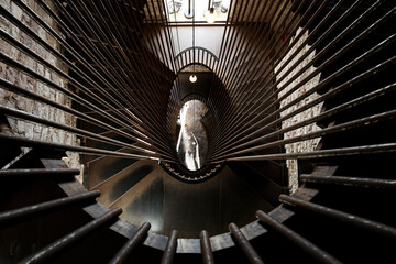 Civic Tower or Torre del Popolo in the Piazza del Comune in Assisi (Perugia). View from inside the staircase in top-down perspective, with iron boundary beams