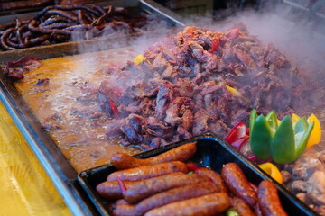 Pork meat cooked in fat at traditional food stand at Christmas market in Bucharest