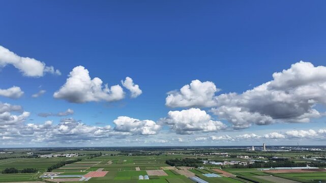 Aerial Agricultural Landscape with White Clouds and Blue Sky