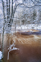Flooding ice covered river in very cold winter day