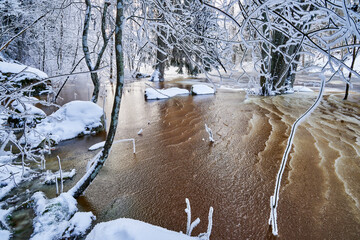 Flooding ice covered river in very cold winter day