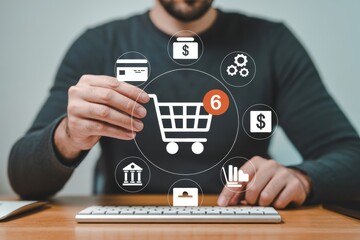 A man sitting at a desk using a computer with online shopping icons floating above the keyboard.