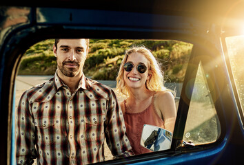 Portrait, car and couple in window for road trip, adventure and travel in countryside together. Flare, dating and man with woman by vehicle for bonding on holiday, vacation and outdoor getaway