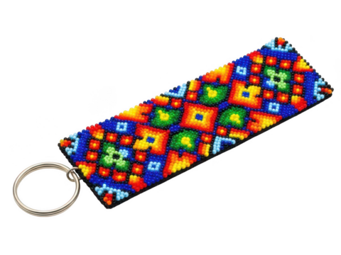 A colorful geometric keychain with a multicolored pattern and a metallic ring attachment isolated on transparent background - Powered by Adobe