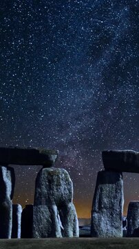 Stonehenge at night. Space background at the famous Stonehenge prehistoric monuments, a massive stone circle located on Salisbury Plain in Wiltshire, England. Smartphone and social media ready.