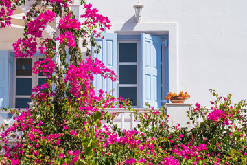 Traditional greek house in Oia, Santorini, Greece with blue windows