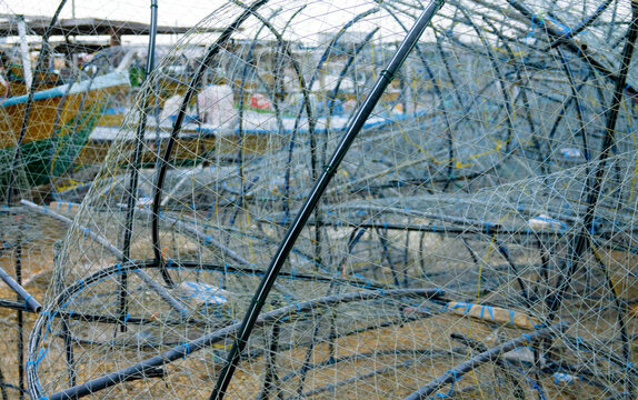 Fishing port in the Persian Gulf. Fishing nets (bottom gill net) are drying on the pier, bag-net fishery, schooners are in a row