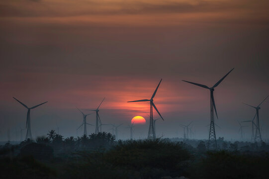 Silhouette of a row of Wind turbines at sunset, Kanyakumari, Tamil Nadu, India