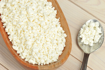 crumbly cottage cheese in a wooden plate