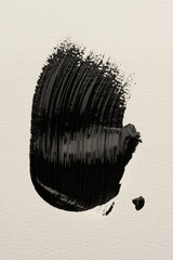 Abstract stroke of black acrylic paint on white paper