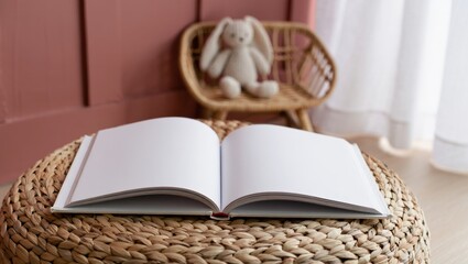 Open hardcover children's book on woven surface with toy in cozy room