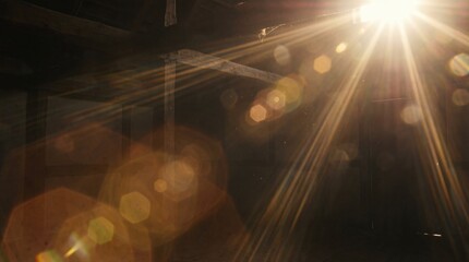 Bright sunlight shine creates lens flare light leak effects in dark background.