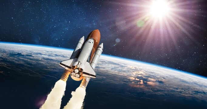 Space shuttle flight from Earth surface into space. The spacecraft in the stars. The launch of rocket carrying astronauts into outer space. Elements of this image furnished by NASA. Not AI.
