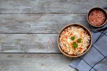Sauerkraut in a ceramic bowl, top view with copy space. Fermented food. Vegetarianism, healthy food.
