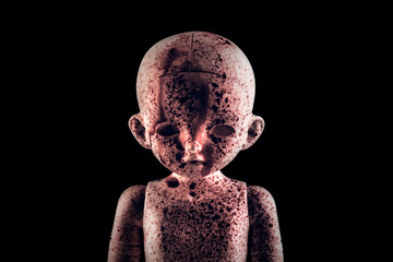 Creepy bloody doll face in the dark