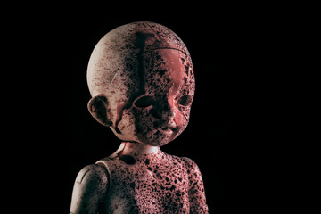 Creepy bloody doll face in the dark