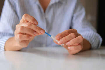 Rapid test strip in hand, respiratory virus screening, influenza, COVID-19, pneumonia, epidemic, healthcare diagnostics, infection control, home self test, copy space