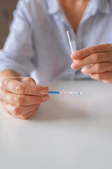 Rapid test strip in hand, respiratory virus screening, influenza, COVID-19, pneumonia, epidemic, healthcare diagnostics, infection control, home self test, copy space