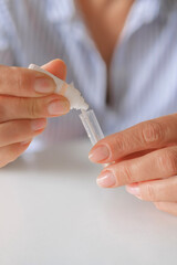 Rapid test strip in hand, respiratory virus screening, influenza, COVID-19, pneumonia, epidemic, healthcare diagnostics, infection control, home self test, copy space