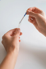 Rapid test strip in hand, respiratory virus screening, influenza, COVID-19, pneumonia, epidemic, healthcare diagnostics, infection control, home self test, copy space