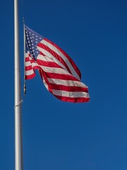 American flag waving in blue sky