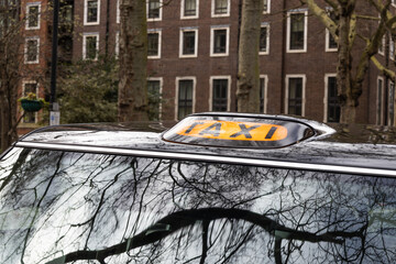 Urban Taxi Cab with Roof Sign in City Street