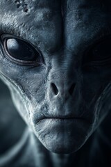 Close view of a fictional alien creature with large eyes and detailed skin texture in a dark setting