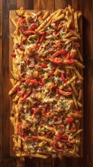 Crispy fries topped with cheese, meat, and vegetables on a wooden board at a restaurant in the evening