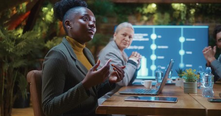 Diverse business team discussing important decisions at table during corporate meeting in modern conference room. - Powered by Adobe
