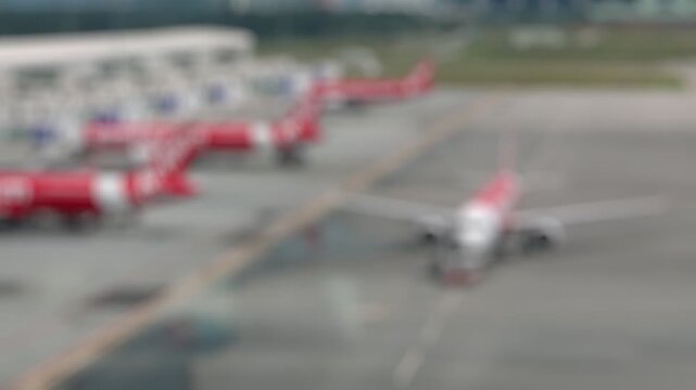 Bokeh view of aircrafts in Lapangan Terbang Antarabangsa Kuala Lumpur from arrival zone, Sepang, Selangor, Malaysia. Blurred background footage.