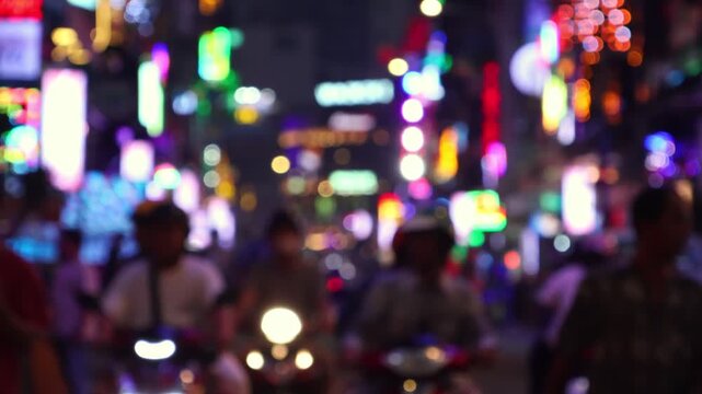 Bokeh view of busy Bui Vien Walking Street - famous New Year party area of Ho Chi Minh City (Saigon), Vietnam. Blurred background footage.