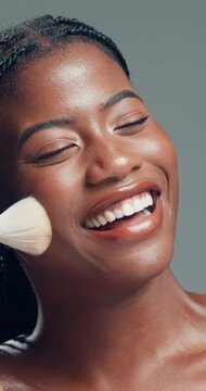 Beauty, brush and laughing with black woman in studio to apply facial foundation product. Contouring, blush makeup and funny with happy African model on gray background for application of cosmetics