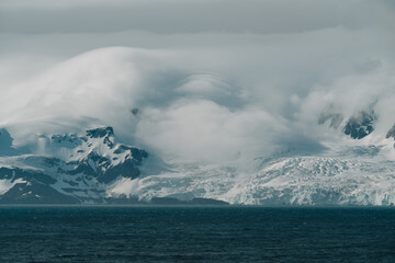 Elephant Island Antarctica Clouds Powerful Snow Storm Rolling in Over Glacier and Mountains. Incredible Nature Beautiful Scene. © And They Travel