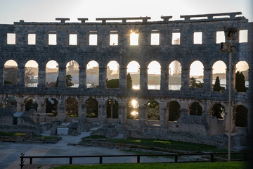 Naklejka premium Sunset through arches of Pula Arena Roman amphitheater, Croatia