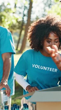 Volunteer, boxes and woman on tablet outdoor for food drive, charity event and collect donation. Happy, team and person on digital tech for checklist, website and online info for outreach program