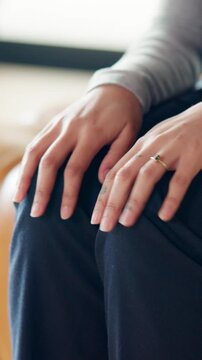 Anxiety, worry and hands of person on sofa for counseling session, therapy and consulting. Psychology, closeup and woman in therapist office with nervous, stress and anxious for mental health support
