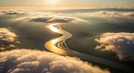 Serene river winding through misty clouds at sunrise  