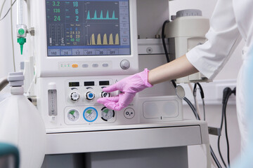 The anesthesiologist prepares the equipment for the operation. Medical care. Equipment for anesthesia and artificial respiration of the patient during surgery.