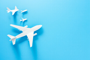 White paper plane casting shadow of airplane on blue background. Concept for travel, business idea, leadership, success, teamwork, creative idea, vision.