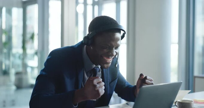 Happy, businessman and celebration in video call with laptop for good news, success or project milestone. Excited, black person and cheer in office with computer for profit goal, achievement and win.