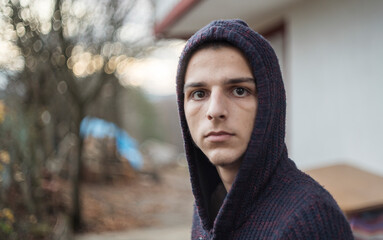 portrait of a young man with a hoodie outside